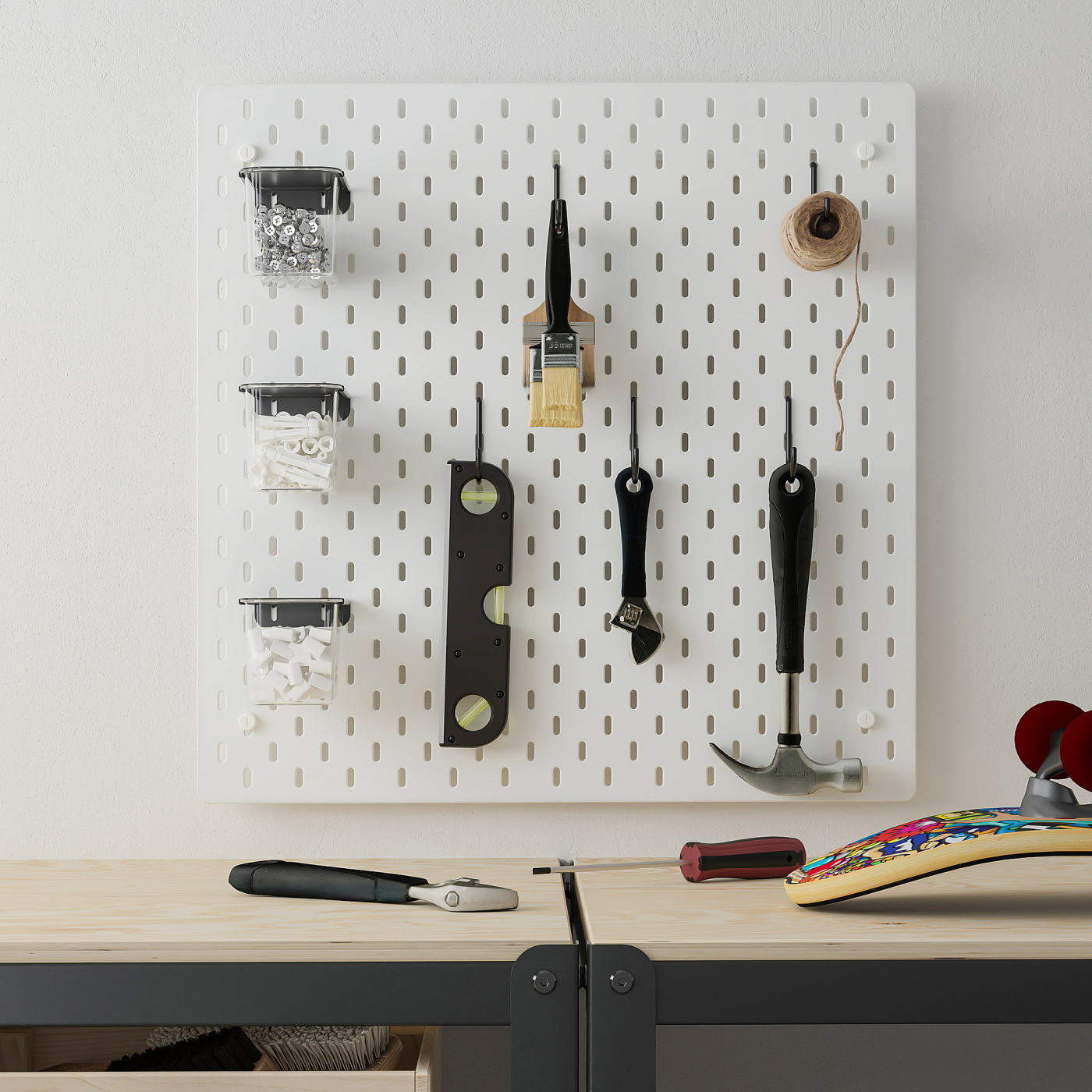 A real SKÅDIS tool wall with hooks, containers, and hand tools above a workbench